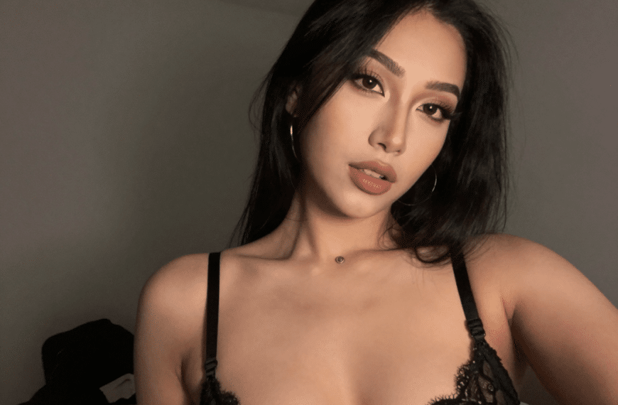 Free Shemale Cam Girl wearing black lingerie, indoors.